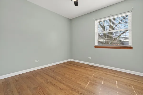 a bedroom with bed and a potted plant