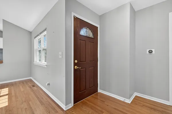 a view of an entryway with wooden floor