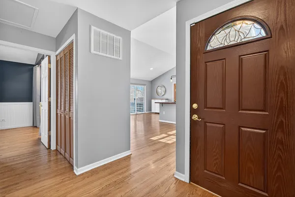 a view of a hallway with wooden floor windows and entryway