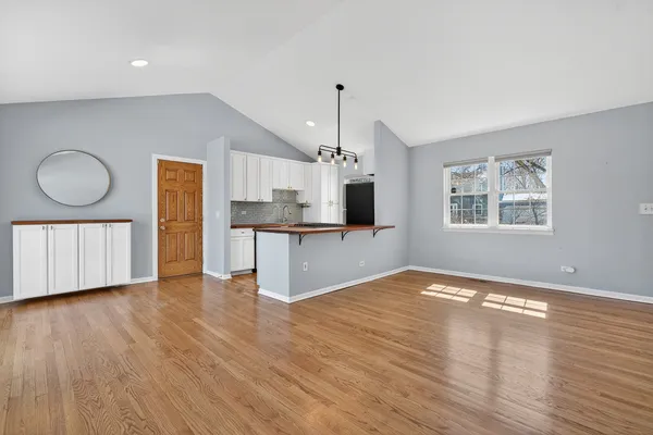 a view of a kitchen with wooden floor and a sink