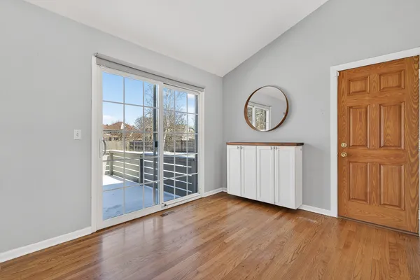 a view of room with wooden floor and windows
