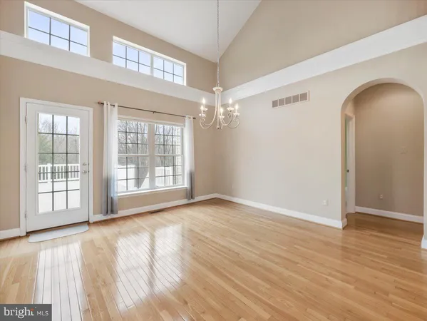 a large kitchen with granite countertop a sink stainless steel appliances and cabinets
