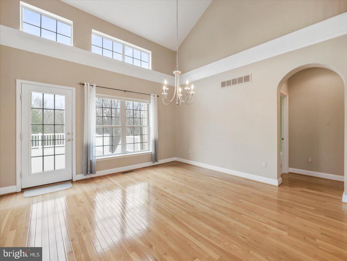 2601 Mill Race Road Frederick, MD 21701 - Photo 12 of 82 a view of an empty room with wooden floor and a window