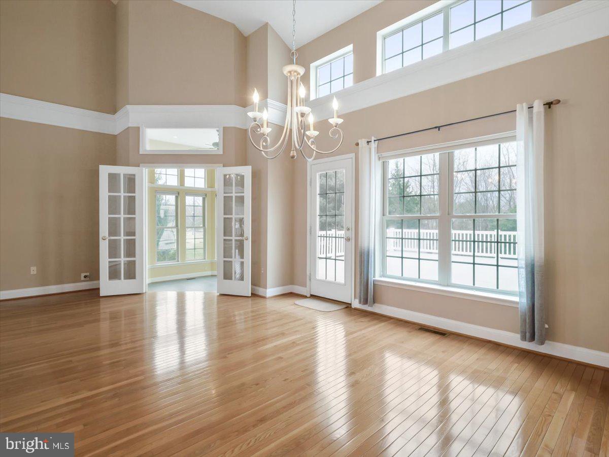 2601 Mill Race Road Frederick, MD 21701 - Photo 13 of 82 a view of an empty room with wooden floor and a window