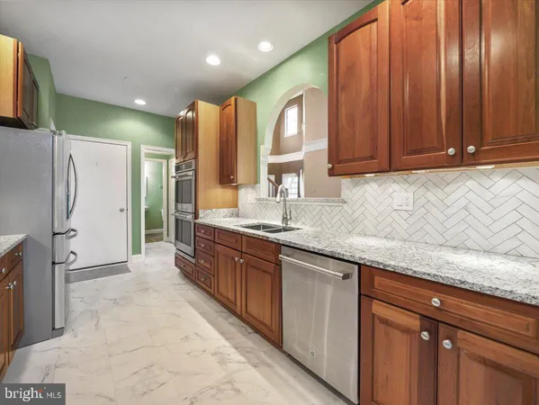 an empty room with a window and a ceiling fan