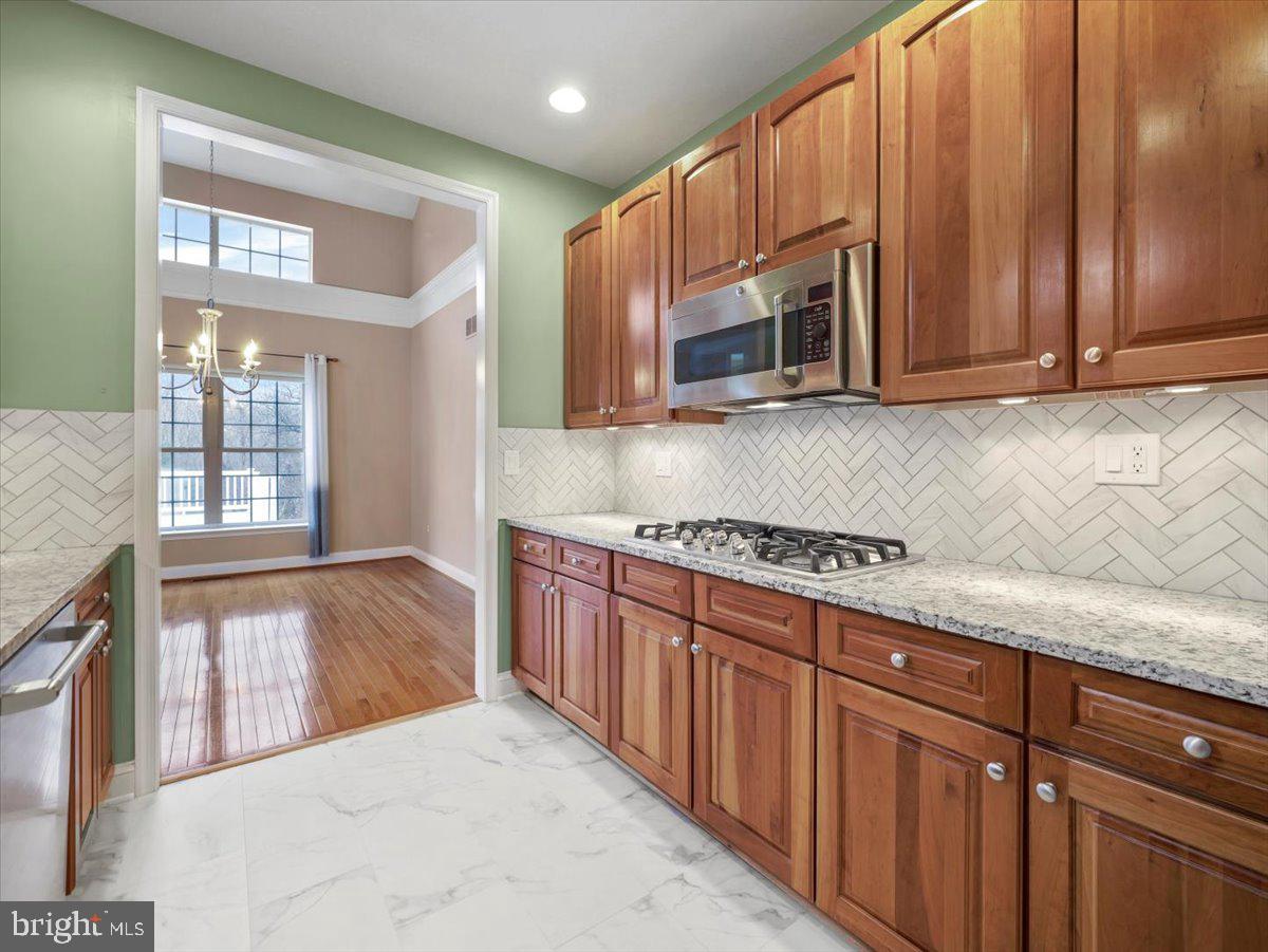 2601 Mill Race Road Frederick, MD 21701 - Photo 19 of 82 a kitchen with stainless steel appliances granite countertop a stove a sink dishwasher and a microwave oven with cabinets