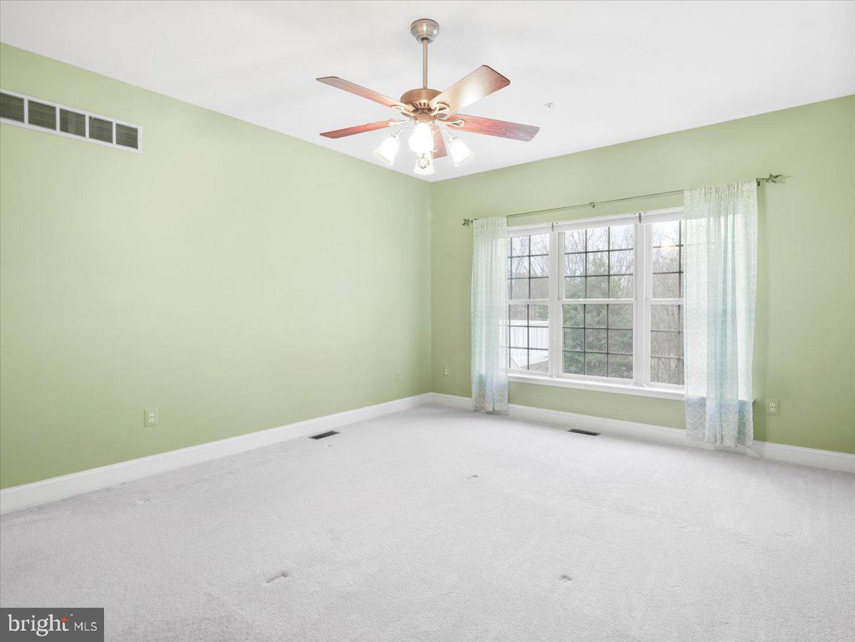 2601 Mill Race Road Frederick, MD 21701 - Photo 24 of 82 an empty room with a window and a ceiling fan