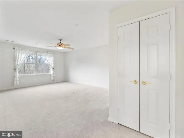 a living room with furniture large window and dining table