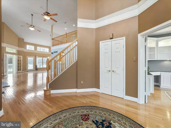 a view of a livingroom with wooden floor and a fireplace