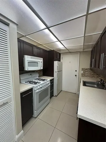 a kitchen with refrigerator and stove