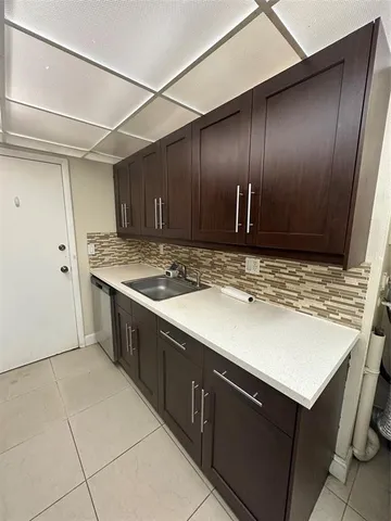 a kitchen with a sink and cabinets
