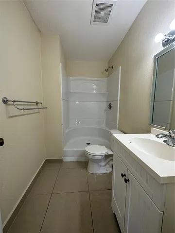 a bathroom with a double vanity sink toilet and shower