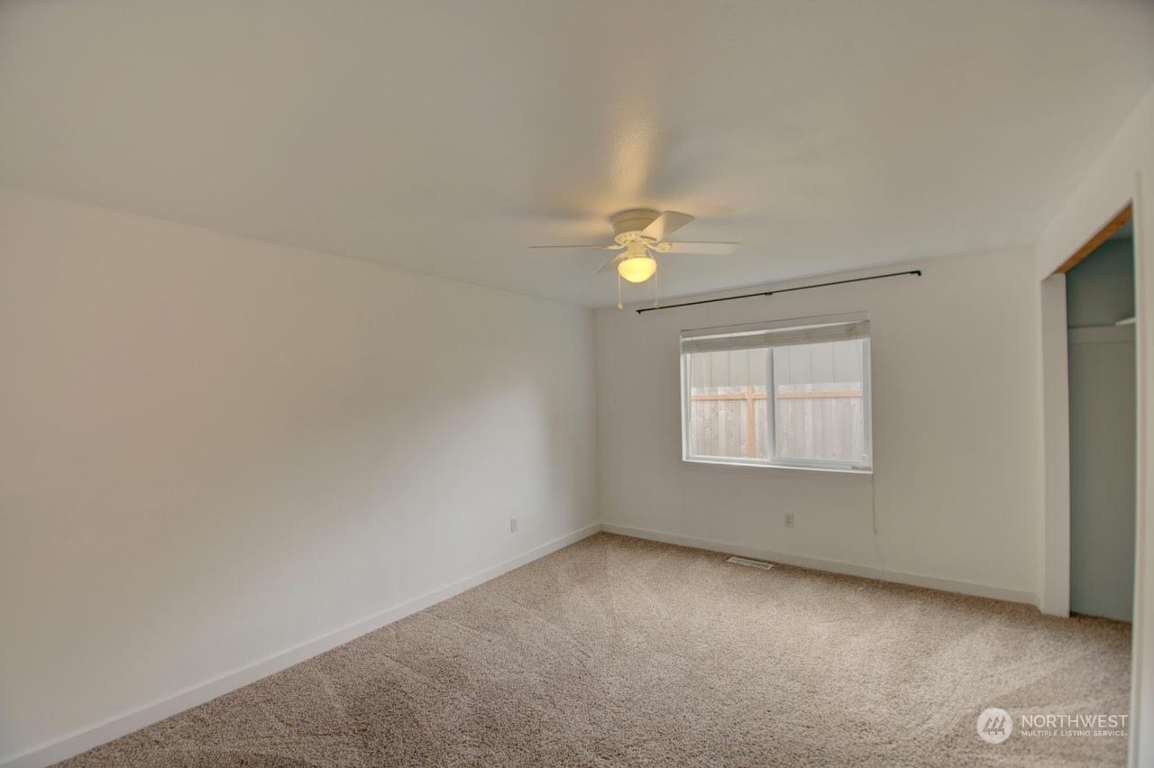 1321 Golf Club Road Southeast Lacey, WA 98503 - Photo 11 of 25 an empty room with windows