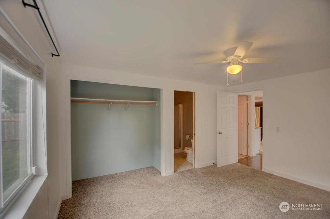 1321 Golf Club Road Southeast Lacey, WA 98503 - Photo 13 of 25 an empty room with closet and a ceiling fan