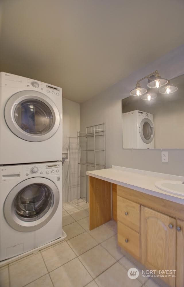 1321 Golf Club Road Southeast Lacey, WA 98503 - Photo 14 of 25 a bathroom with a sink a washer and dryer
