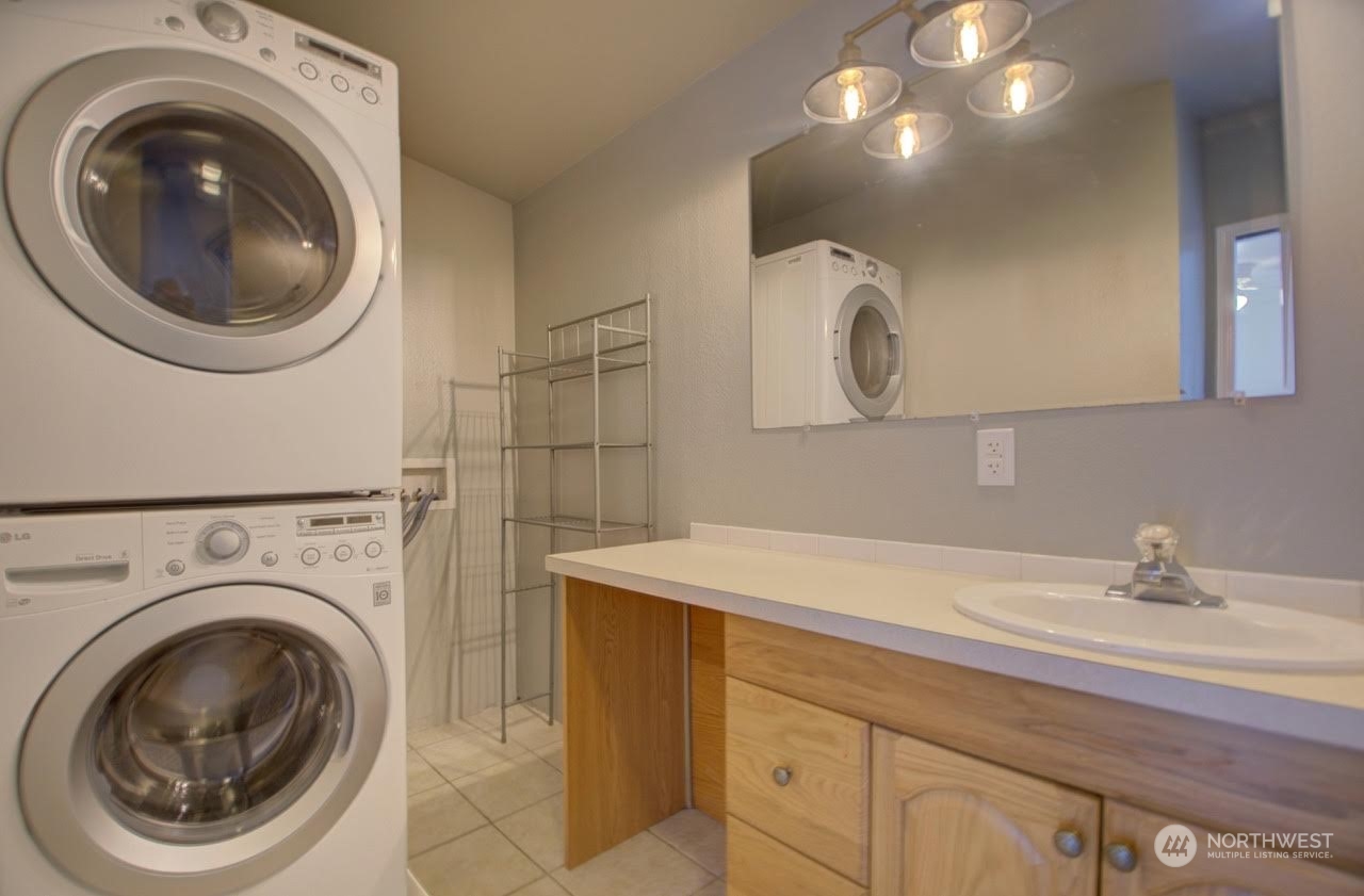 1321 Golf Club Road Southeast Lacey, WA 98503 - Photo 15 of 25 a bathroom with a sink a washer and dryer