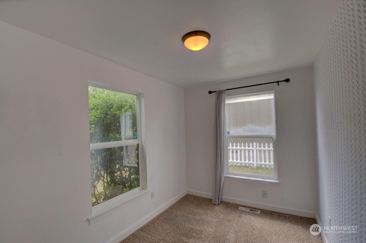 1321 Golf Club Road Southeast Lacey, WA 98503 - Photo 19 of 25 an empty room with windows