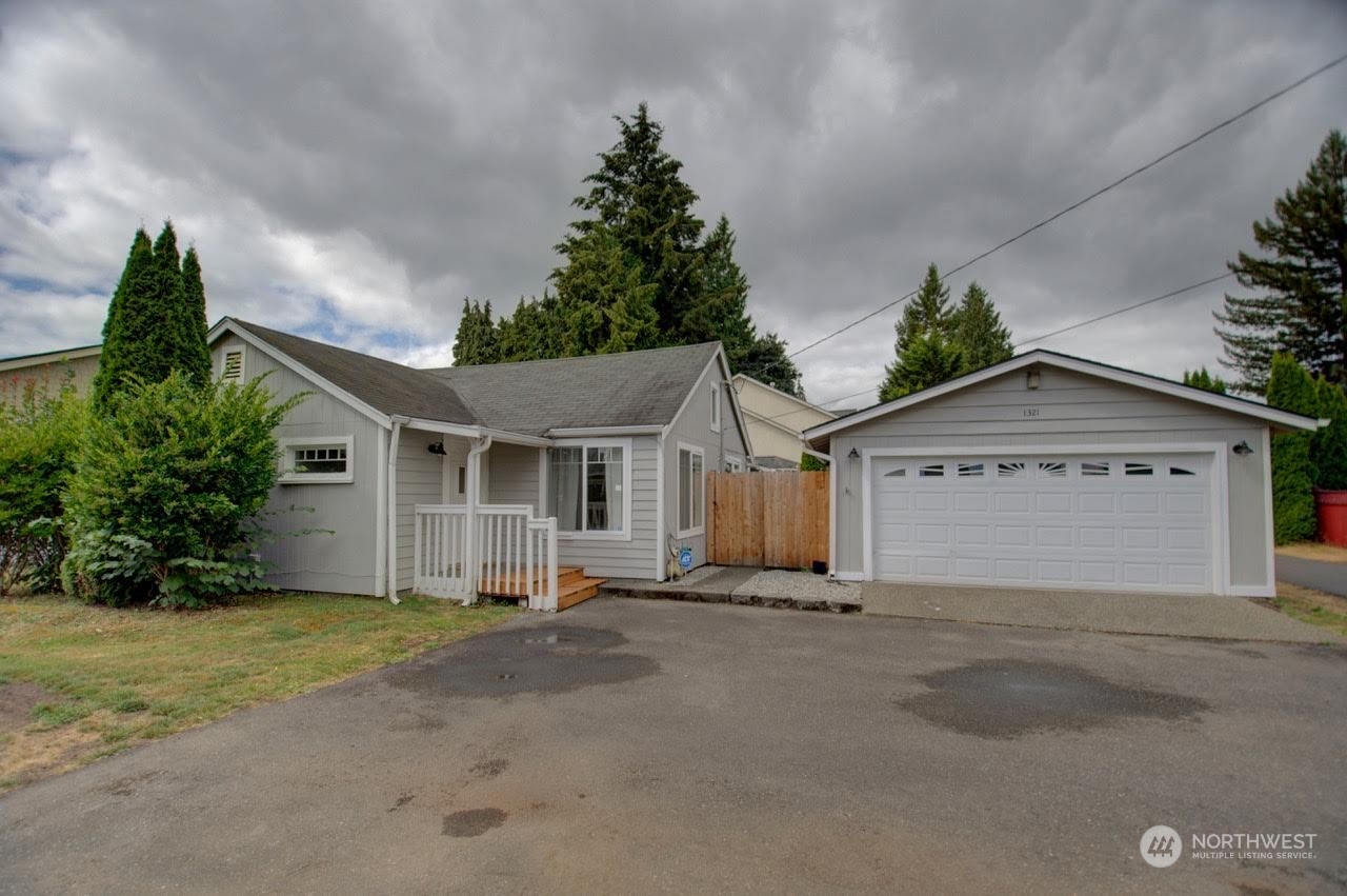 1321 Golf Club Road Southeast Lacey, WA 98503 - Photo 2 of 25 a view of a house with a yard and garage