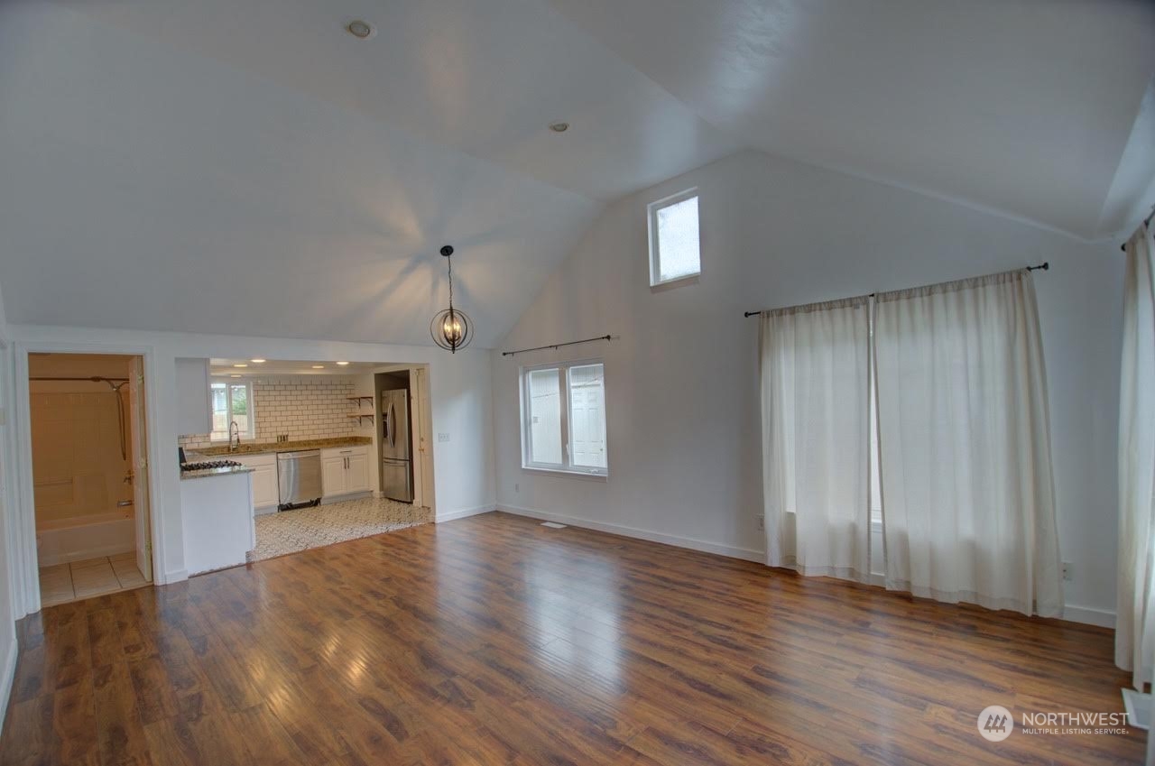 1321 Golf Club Road Southeast Lacey, WA 98503 - Photo 5 of 25 a view of an empty room with a window and wooden floor