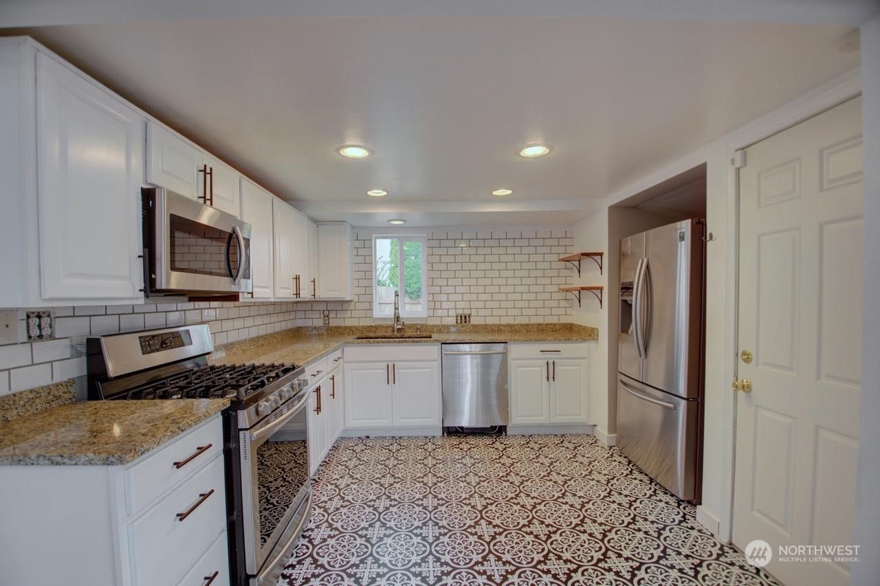 1321 Golf Club Road Southeast Lacey, WA 98503 - Photo 7 of 25 a kitchen with a refrigerator sink and microwave