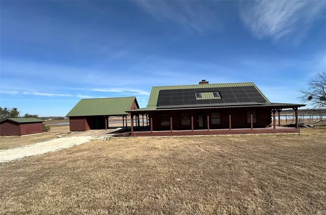 a view of a large building with a big yard and large trees