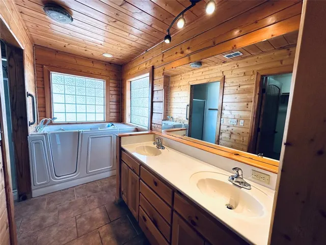 a bathroom with a sink double vanity and a mirror