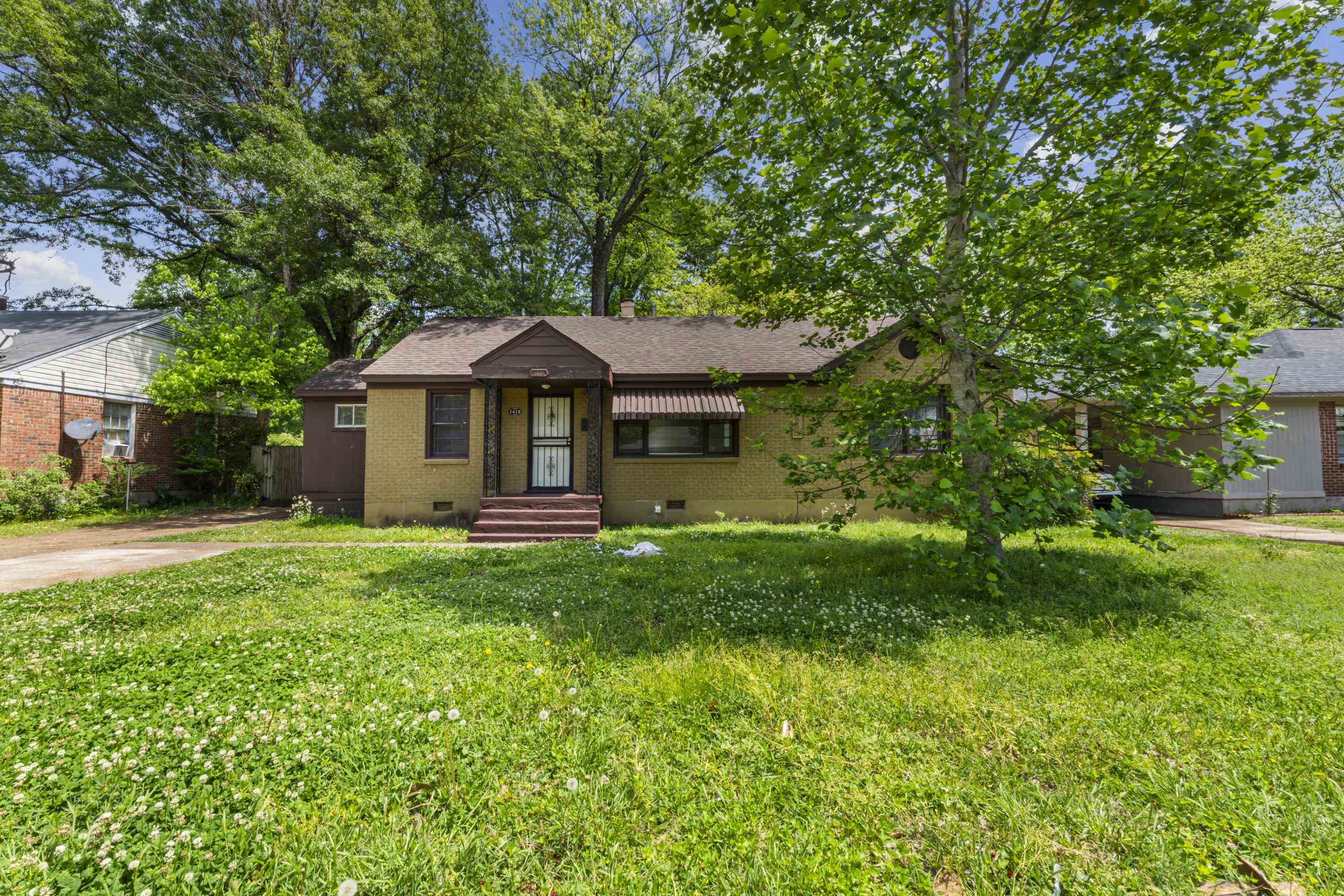 1418 South Perkins Road Memphis, TN 38117 - Photo 1 of 21 a front view of a house with a garden