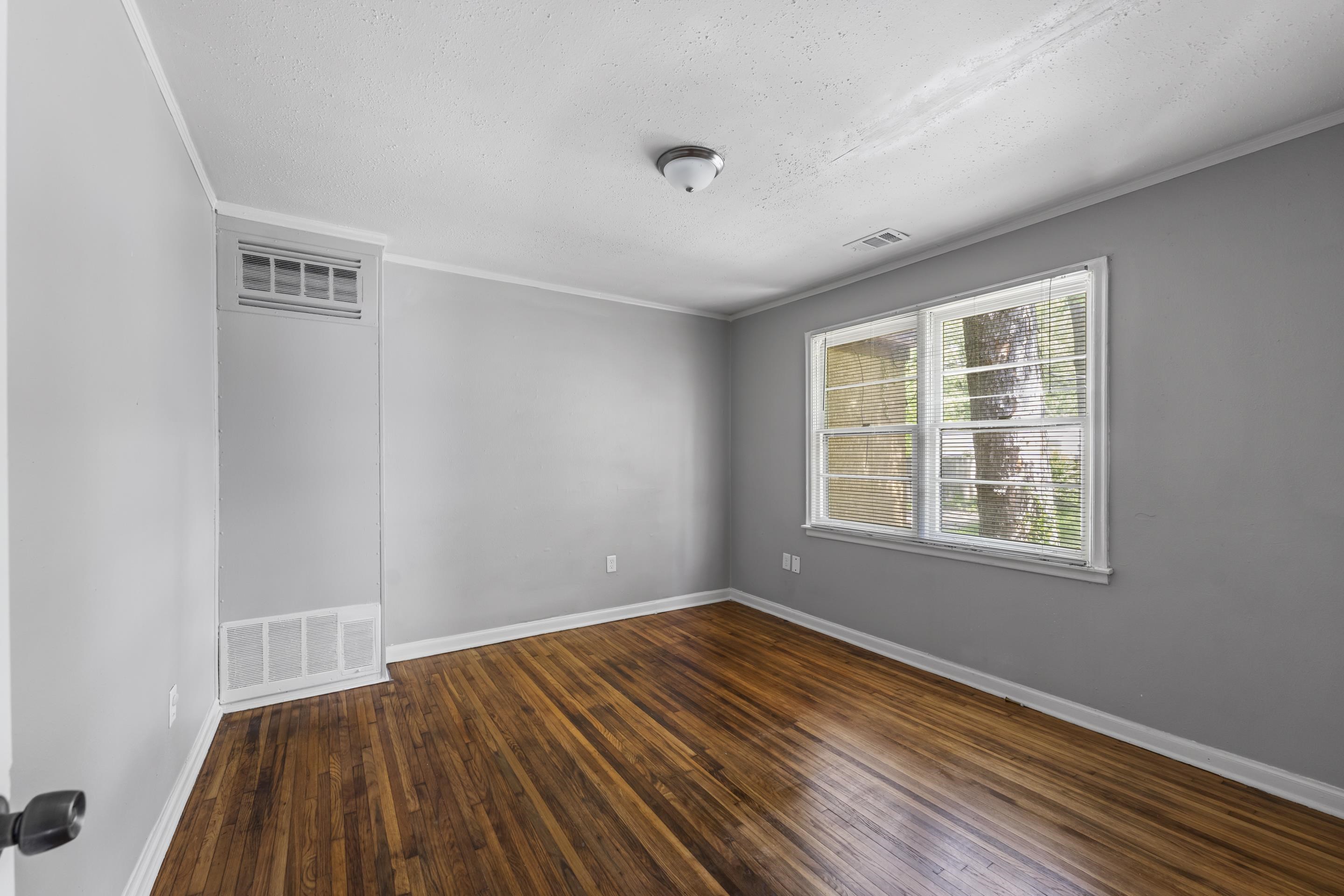 1418 South Perkins Road Memphis, TN 38117 - Photo 12 of 21 a view of empty room with wooden floor and fan