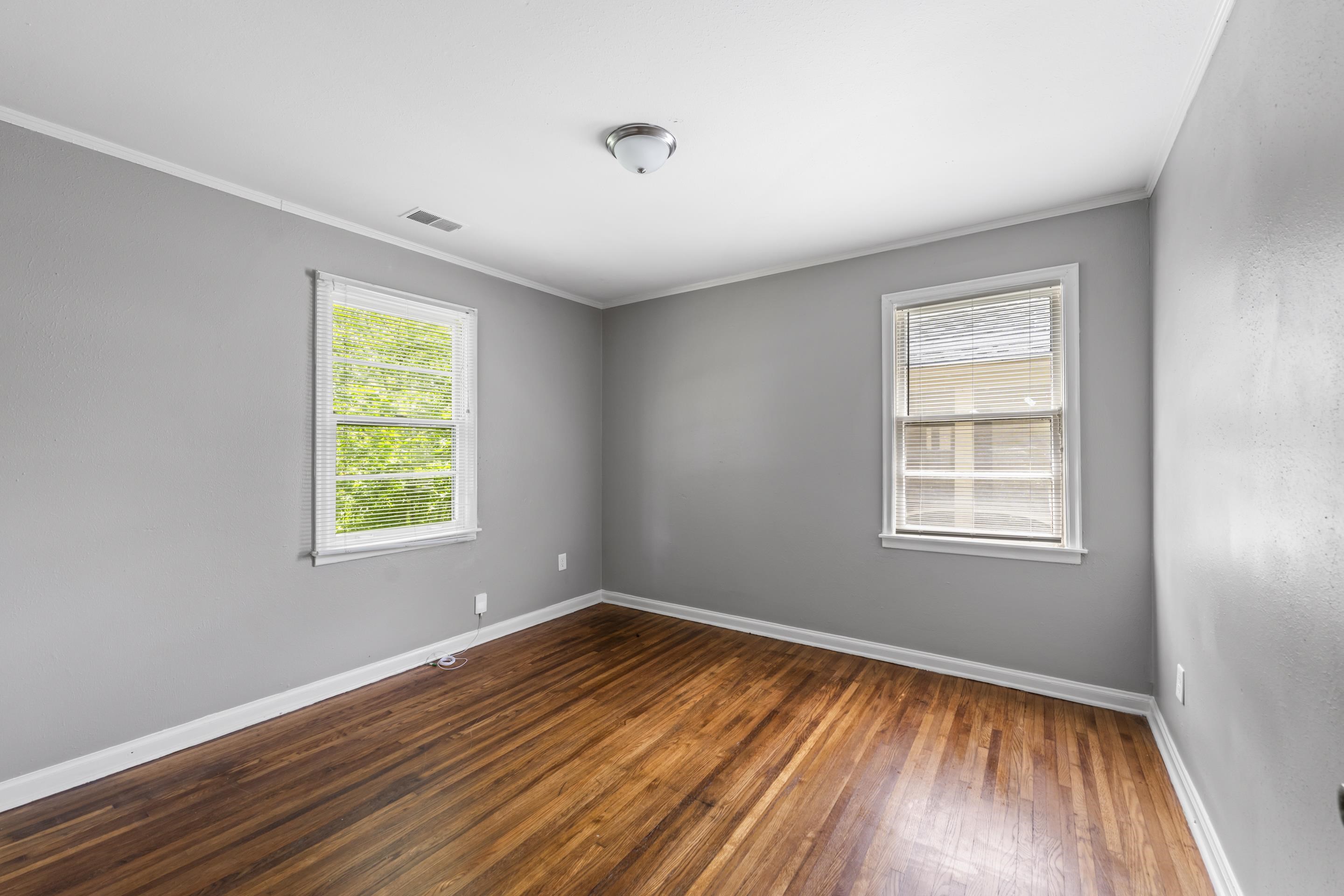 1418 South Perkins Road Memphis, TN 38117 - Photo 14 of 21 a view of an empty room with wooden floor and a window
