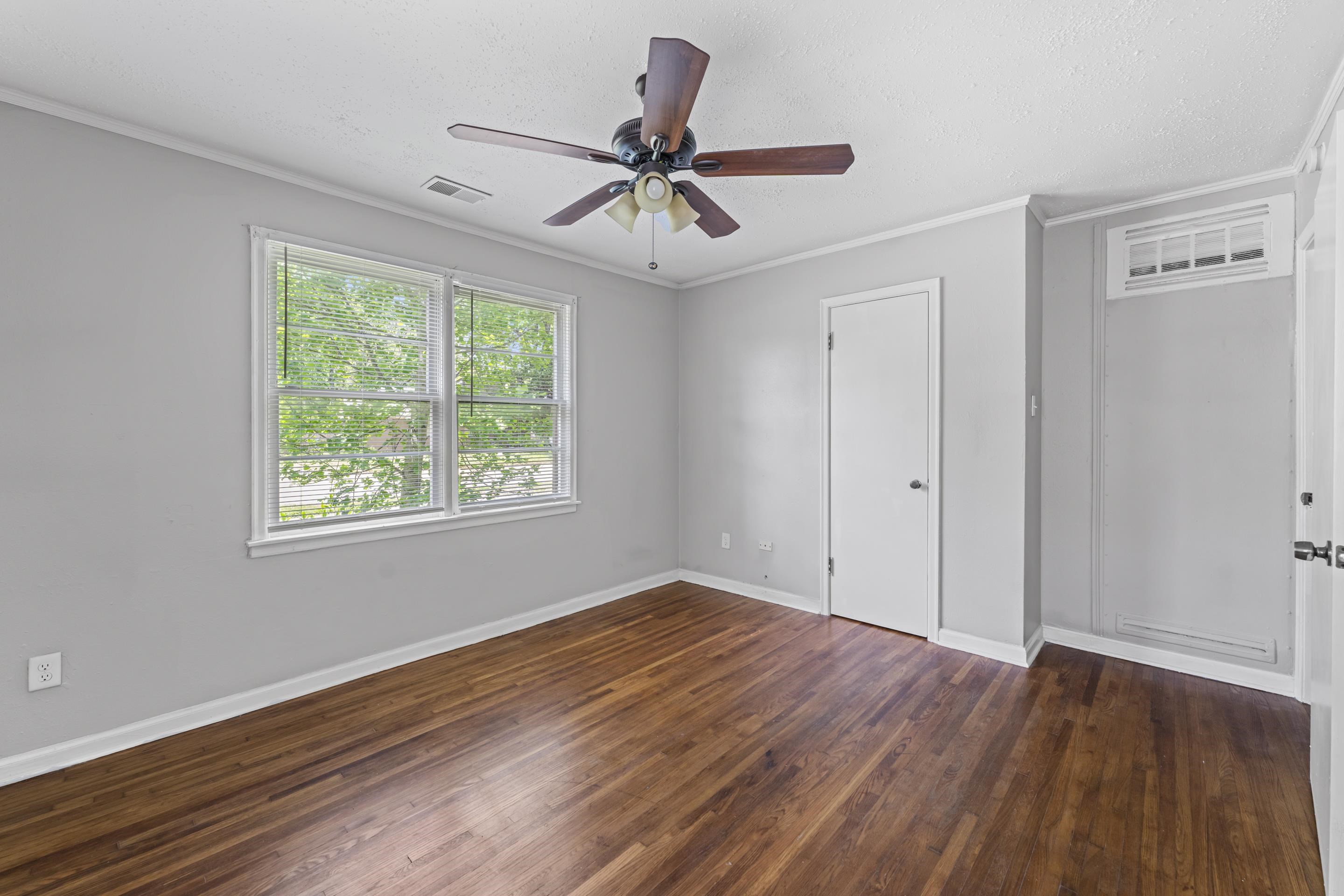 1418 South Perkins Road Memphis, TN 38117 - Photo 17 of 21 a view of a room with wooden floor fan and windows
