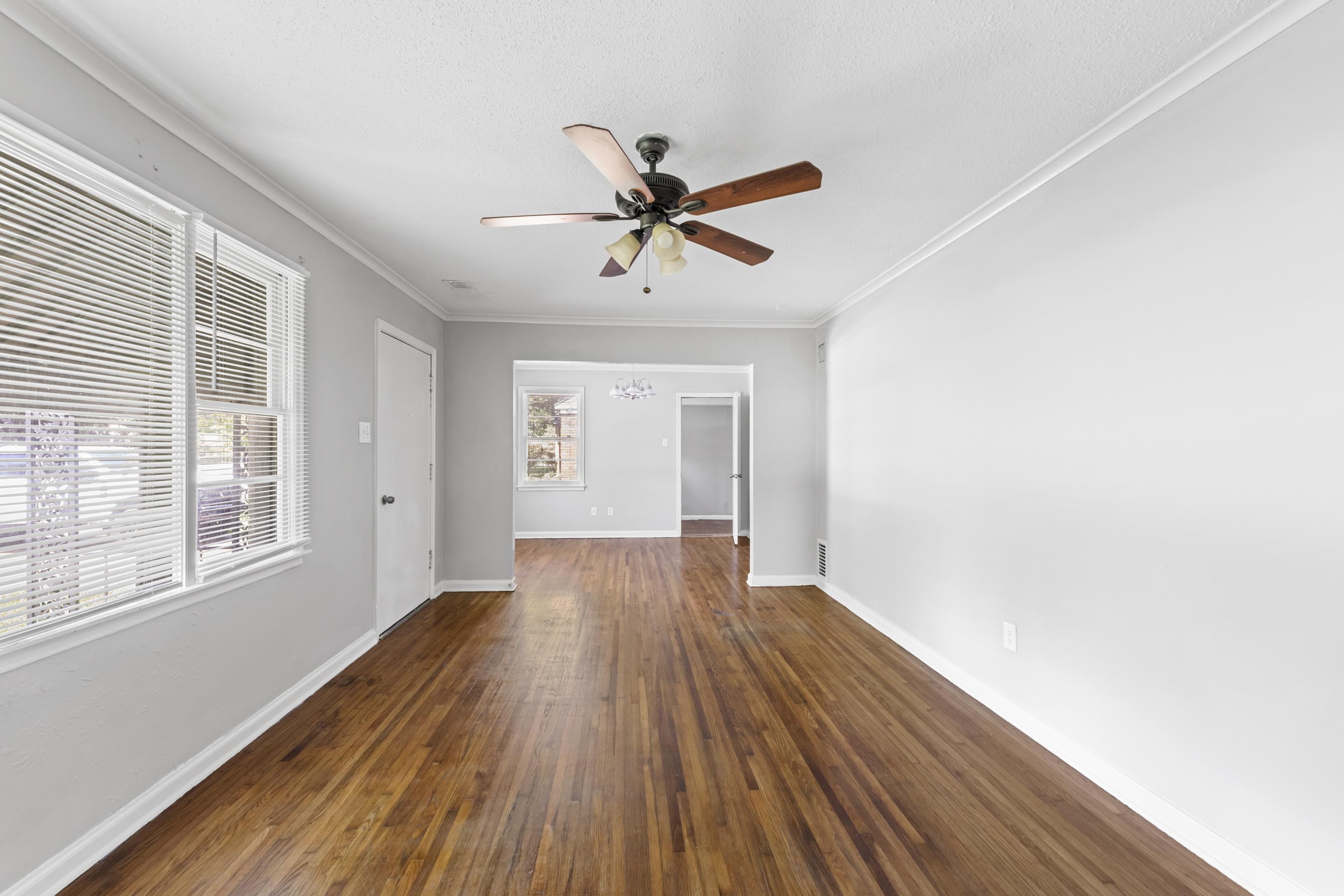 1418 South Perkins Road Memphis, TN 38117 - Photo 2 of 21 a view of a livingroom with wooden floor and a ceiling fan