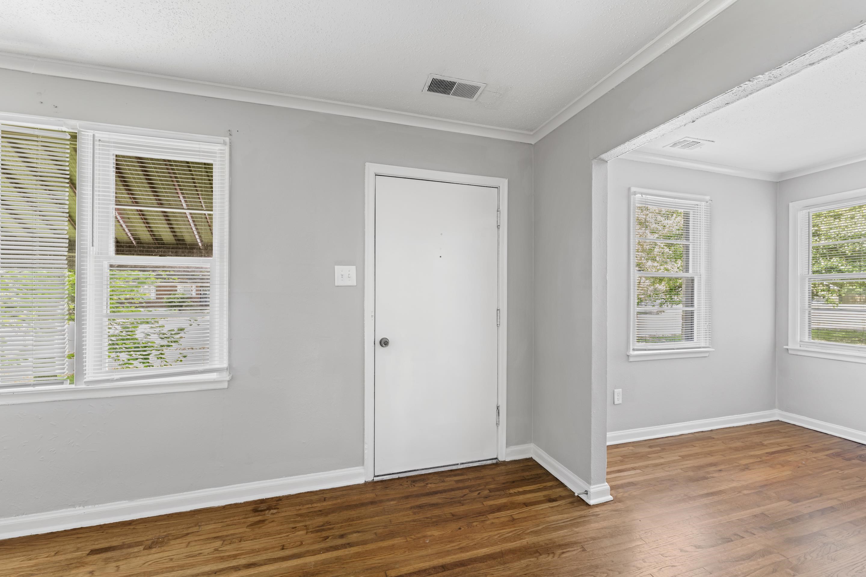 1418 South Perkins Road Memphis, TN 38117 - Photo 8 of 21 a view of an empty room with wooden floor and a window
