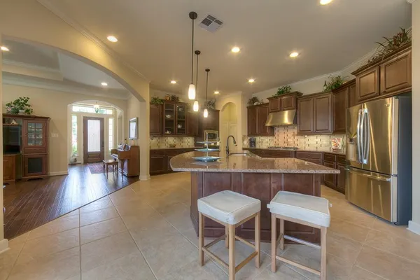a large kitchen with a table and chairs