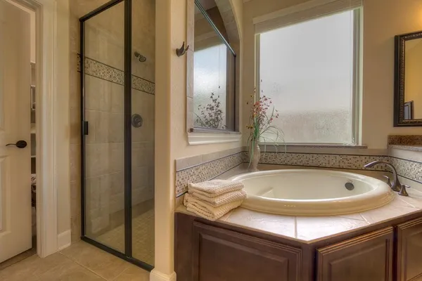 a bathroom with a tub and shower