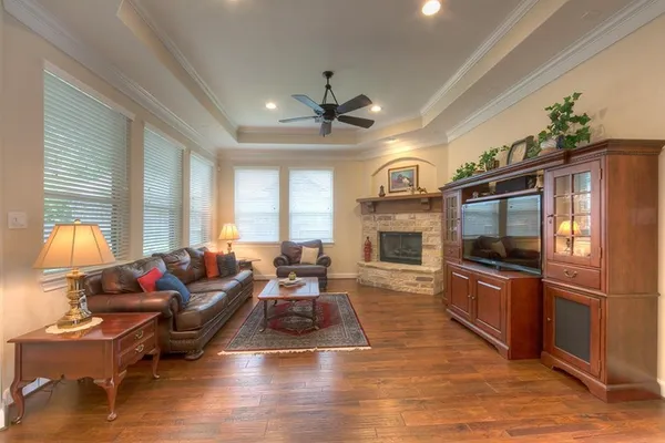 a living room with furniture fireplace and flat screen tv