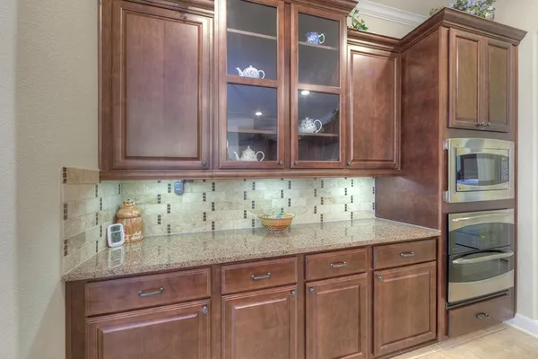 a kitchen with granite countertop stainless steel appliances sink and cabinets