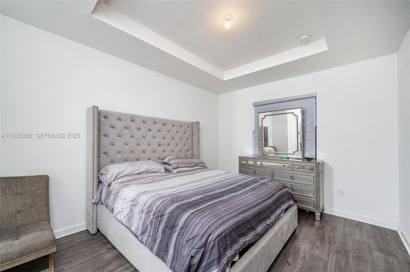 23061 Southwest 128th Place Miami, FL 33177 - Photo 14 of 28 a bedroom with bed and wooden floor