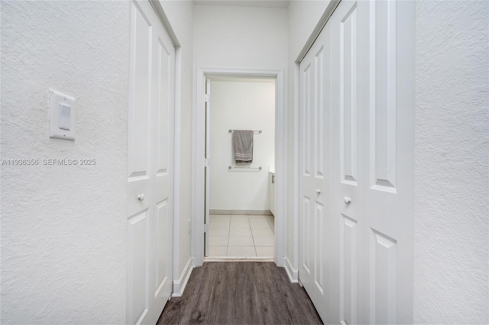 23061 Southwest 128th Place Miami, FL 33177 - Photo 16 of 28 a view of a hallway with wooden floor