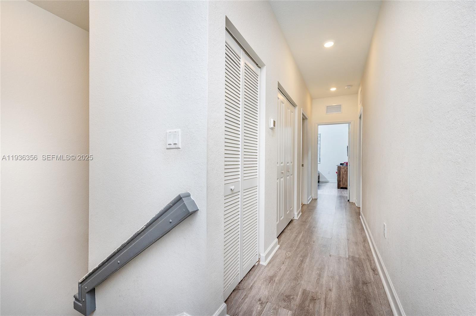 23061 Southwest 128th Place Miami, FL 33177 - Photo 18 of 28 a view of a hallway with wooden floor and staircase