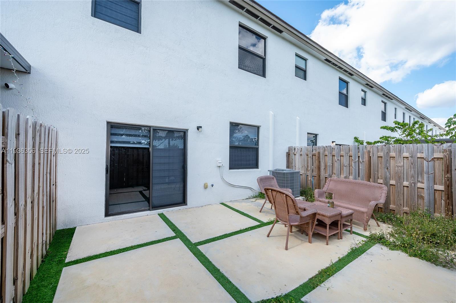 23061 Southwest 128th Place Miami, FL 33177 - Photo 24 of 28 a patio with a table and chairs