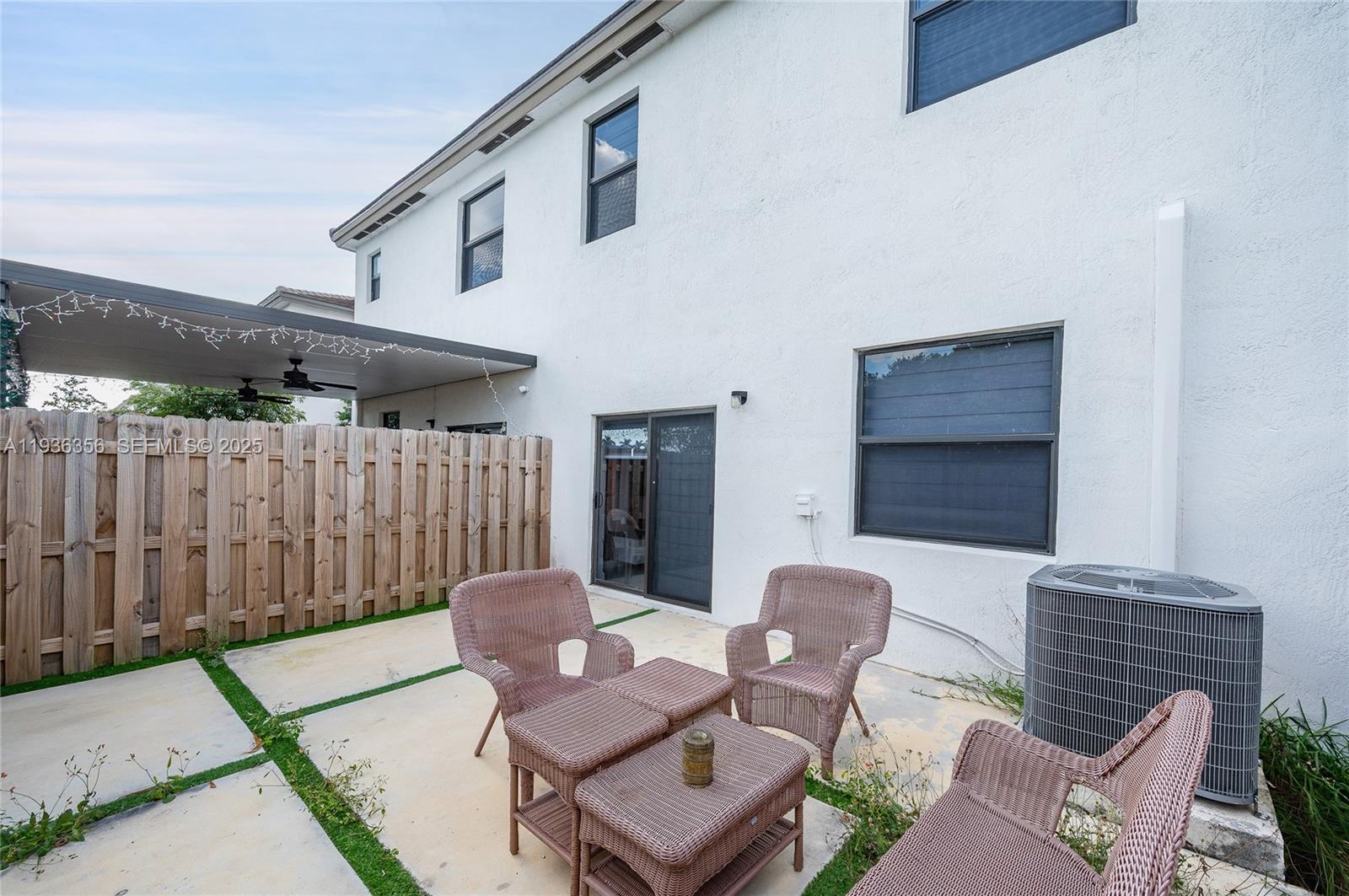 23061 Southwest 128th Place Miami, FL 33177 - Photo 25 of 28 a view of a patio with a table and chairs