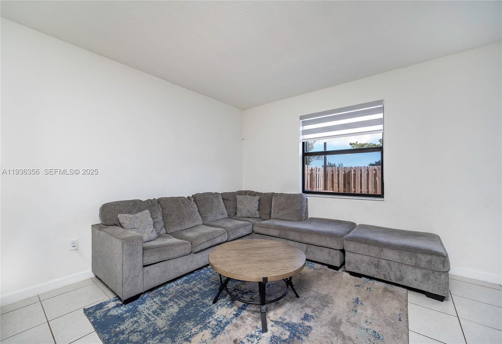23061 Southwest 128th Place Miami, FL 33177 - Photo 8 of 28 a living room with furniture and a rug