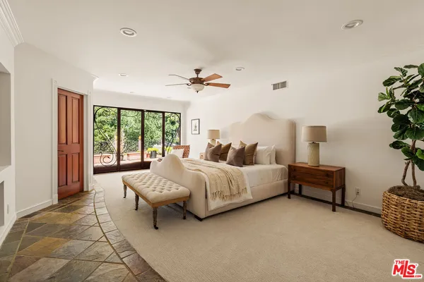 a bathroom with a granite countertop sink mirror bathtub and next to a window