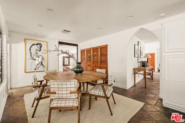 a kitchen with stainless steel appliances granite countertop a refrigerator a stove a sink and white cabinets