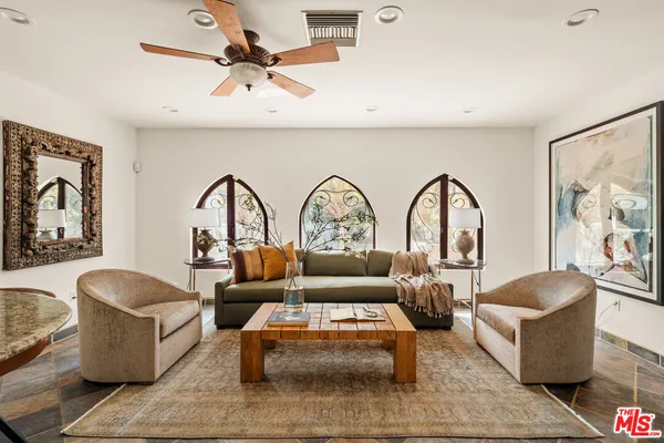 a kitchen with granite countertop a sink window and cabinets