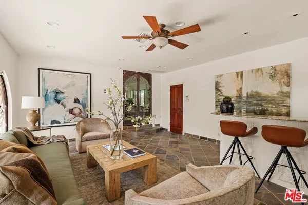 a kitchen with granite countertop a refrigerator and cabinets