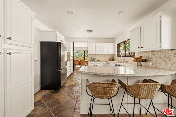 a spacious bedroom with a bed and a couch