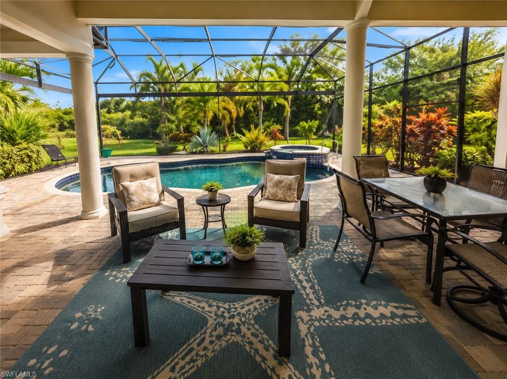 6574 Amarone Lane Naples, FL 34113 - Photo 36 of 44 a view of a patio with a table chairs and a table