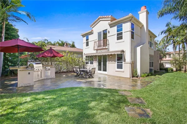 a view of a house with backyard sitting area and garden