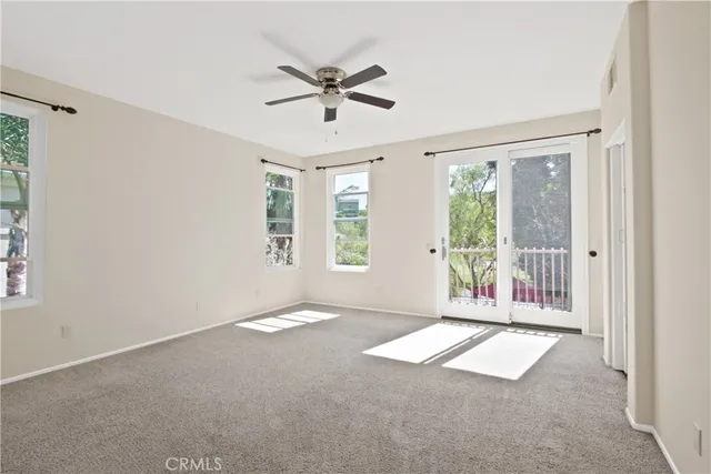 a view of a livingroom with a ceiling fan and window